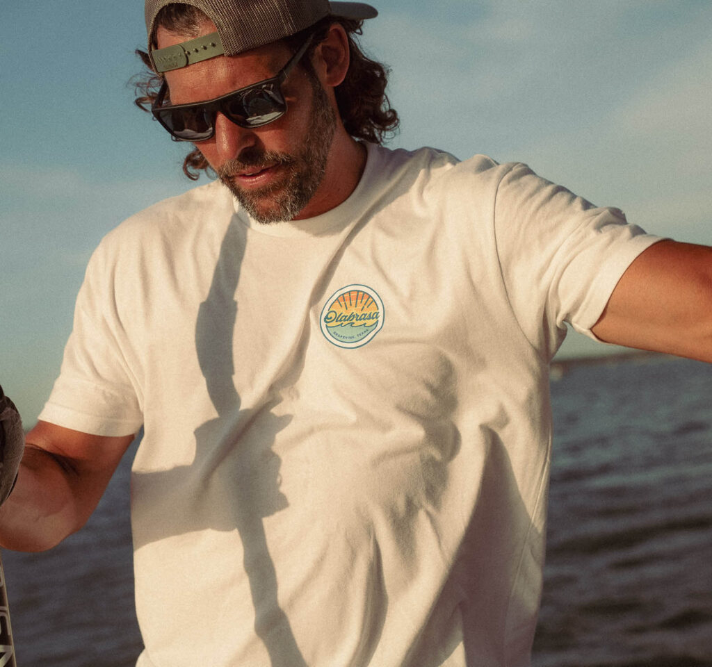 Man on boat wearing Olabrasa OG T-Shirt