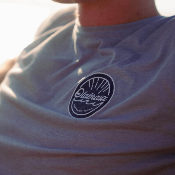 Man enjoying a sunny boat ride wearing Olabrasa OG T-Shirt